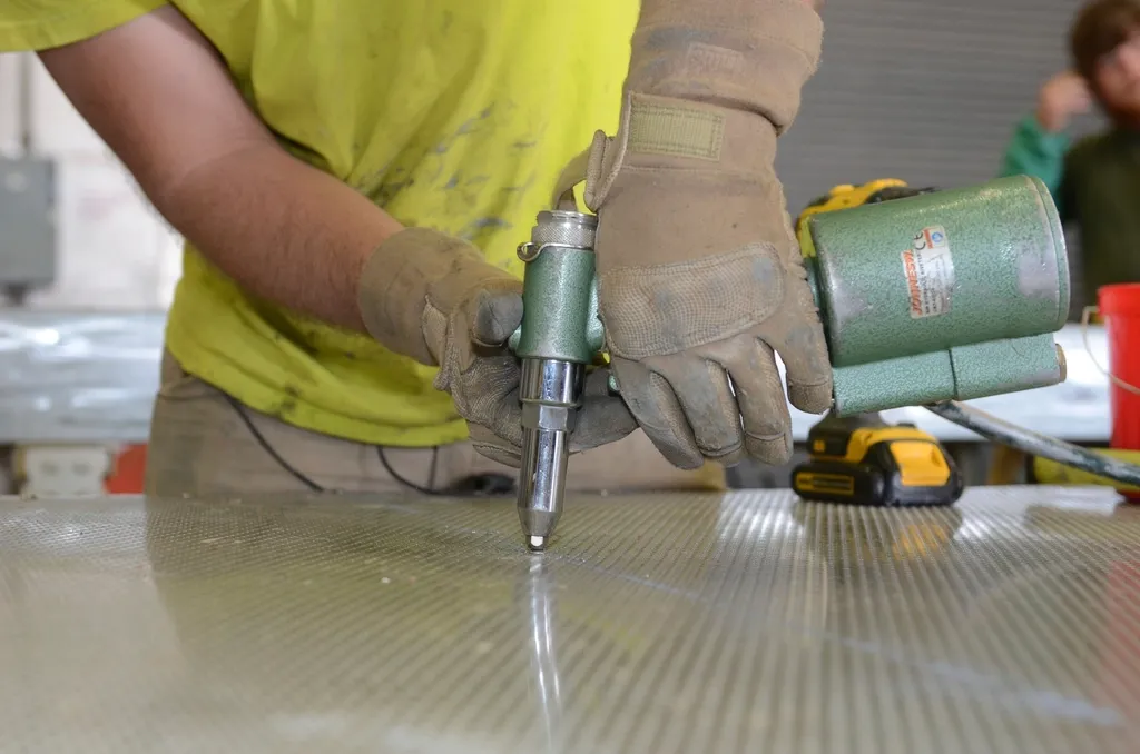 Builder fixing a floor with a power tool