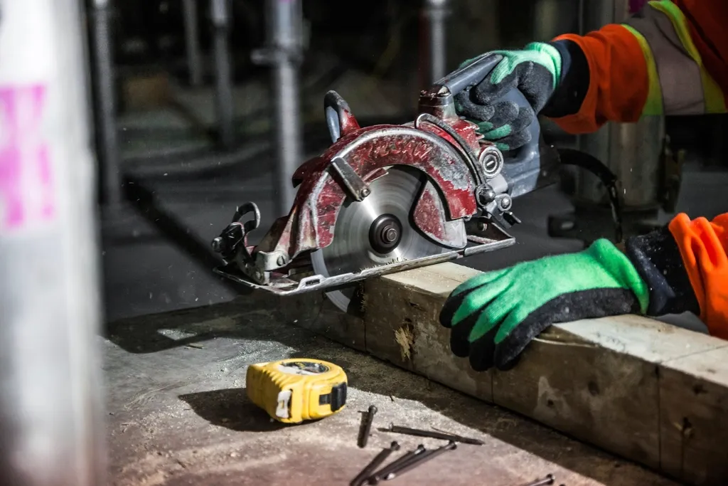 Carpenter cutting a board with a circular saw